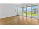 Bright living space with wood-look flooring and sliding glass doors to the backyard at 1126 Olivine Ave, Dundee, FL 33838