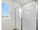 Tiled shower area with sliding glass door in a bright, modern bathroom with a window at 1650 Sugarbelle Cir, Mascotte, FL 34753