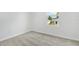 Cozy bedroom with gray carpet, white walls, and a window overlooking the neighborhood at 1650 Sugarbelle Cir, Mascotte, FL 34753