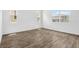 Well-lit room featuring neutral paint, stylish wood flooring, and bright windows for natural light at 1650 Sugarbelle Cir, Mascotte, FL 34753