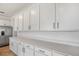 Spacious kitchen featuring expansive countertops, modern appliances, and ample white cabinet storage at 1650 Sugarbelle Cir, Mascotte, FL 34753
