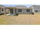 Backyard features an open lawn and covered porch at 1690 Sugarbelle Cir, Mascotte, FL 34753