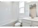 Clean bathroom featuring a vanity, toilet, tub, and window letting in ample natural light at 1690 Sugarbelle Cir, Mascotte, FL 34753