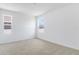 Bright bedroom features plush carpeting and two windows at 1690 Sugarbelle Cir, Mascotte, FL 34753