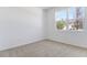 Cozy bedroom featuring neutral carpet, a large window offering natural light, and freshly painted walls at 1690 Sugarbelle Cir, Mascotte, FL 34753