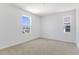 Bright bedroom features plush carpeting and two windows at 1690 Sugarbelle Cir, Mascotte, FL 34753