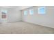 Spacious bedroom with plush carpeting and three windows at 1690 Sugarbelle Cir, Mascotte, FL 34753