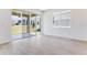 Bright and airy living room boasting tile floors, sliding glass doors and neutral walls at 1690 Sugarbelle Cir, Mascotte, FL 34753