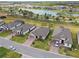 Aerial view of the home, showing well-maintained landscaping and the brick driveway, with lake view at 204 Bella Cortina Dr, Poinciana, FL 34759