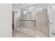 Modern bathroom featuring a glass-enclosed shower with tile surround and a built-in bench at 204 Bella Cortina Dr, Poinciana, FL 34759