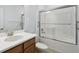 Bathroom featuring a toilet and a vanity with a modern faucet and a shower with sliding glass doors at 204 Bella Cortina Dr, Poinciana, FL 34759