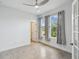 Bright bedroom with tile flooring, modern lighting, and French doors opening to another room at 204 Bella Cortina Dr, Poinciana, FL 34759