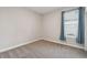 Cozy bedroom with neutral carpet, a window with blinds and blue curtains, and ample natural light at 204 Bella Cortina Dr, Poinciana, FL 34759