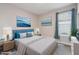 Bedroom features a bed with blue pillows and wall decor creating a soothing and relaxing atmosphere at 204 Bella Cortina Dr, Poinciana, FL 34759