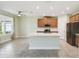 Modern kitchen with a central island, stainless steel appliances, and abundant counter space at 204 Bella Cortina Dr, Poinciana, FL 34759