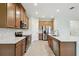 Bright kitchen features stainless appliances, spacious countertops and stylish backsplash at 204 Bella Cortina Dr, Poinciana, FL 34759