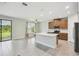 Bright kitchen features an island, stainless steel appliances, and a seamless transition to the outdoor living area at 204 Bella Cortina Dr, Poinciana, FL 34759