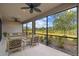 Screened lanai with stylish furniture, ceiling fans, and a scenic view of the green backyard at 204 Bella Cortina Dr, Poinciana, FL 34759