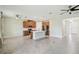 Bright living room showcases an open floor plan connecting to the kitchen with a central island and stainless appliances at 204 Bella Cortina Dr, Poinciana, FL 34759