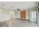 Open living room featuring tile flooring, built-in shelving, wood accent wall, and a ceiling fan at 204 Bella Cortina Dr, Poinciana, FL 34759
