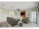 Cozy living room featuring modern furniture, a wooden accent wall with mounted TV, and stylish built-in shelving at 204 Bella Cortina Dr, Poinciana, FL 34759