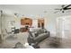 Spacious living room with an open floor plan leading to the kitchen and dining area, perfect for entertaining at 204 Bella Cortina Dr, Poinciana, FL 34759