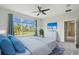 Comfortable main bedroom with a large window offering a view of the well-manicured yard at 204 Bella Cortina Dr, Poinciana, FL 34759