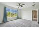 Spacious main bedroom is bright with lots of natural light and neutral décor, creating a peaceful retreat at 204 Bella Cortina Dr, Poinciana, FL 34759