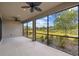 Screened lanai featuring ceiling fans and an expansive green space view, perfect for relaxation at 204 Bella Cortina Dr, Poinciana, FL 34759