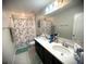 Bathroom featuring double sinks, tiled floors, and a shower-tub combo at 4871 Coral Castle Dr, Kissimmee, FL 34746