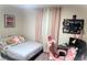 Bedroom featuring a bed with plush pillows and a pink desk area at 4871 Coral Castle Dr, Kissimmee, FL 34746
