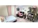 Charming bedroom space with an abundance of decorative shelves at 4871 Coral Castle Dr, Kissimmee, FL 34746