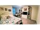 Bright bedroom features a vanity area and a large dresser with a TV at 4871 Coral Castle Dr, Kissimmee, FL 34746