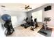 Home exercise room with a variety of exercise equipment, including a treadmill, stationary bikes, and weights at 4871 Coral Castle Dr, Kissimmee, FL 34746