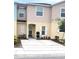 Charming townhouse featuring a well-maintained front yard and neutral color palette at 4871 Coral Castle Dr, Kissimmee, FL 34746