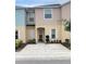 Charming townhouse featuring a well-maintained front yard and neutral color palette at 4871 Coral Castle Dr, Kissimmee, FL 34746