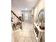 Inviting foyer featuring tiled floor, staircase, and decorative console table at 4871 Coral Castle Dr, Kissimmee, FL 34746