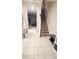 Inviting foyer featuring tiled floor, staircase, and an open view to the living room at 4871 Coral Castle Dr, Kissimmee, FL 34746
