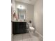 Stylish half bathroom with modern vanity, fixtures, and a neutral color scheme at 4871 Coral Castle Dr, Kissimmee, FL 34746