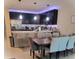 Open concept kitchen features black cabinetry, quartz countertops, stainless steel appliances and dining area at 4871 Coral Castle Dr, Kissimmee, FL 34746