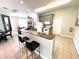 Open-concept kitchen featuring gray cabinets, granite countertops, stainless steel appliances, and bar seating at 4871 Coral Castle Dr, Kissimmee, FL 34746