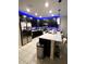 Modern kitchen featuring black cabinets, stainless steel appliances and white quartz countertops with barstool seating at 4871 Coral Castle Dr, Kissimmee, FL 34746