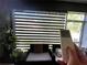 Comfortable lanai seating area with remote-controlled shades for adjustable light and privacy at 4871 Coral Castle Dr, Kissimmee, FL 34746
