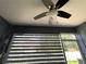 Screened-in lanai featuring a ceiling fan and adjustable shades for optimal comfort at 4871 Coral Castle Dr, Kissimmee, FL 34746