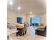 Bright living room features modern furnishings, tile flooring, and sliding glass doors to outdoor space at 4871 Coral Castle Dr, Kissimmee, FL 34746