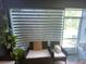 Screened patio with comfortable seating, plants, and natural light at 4871 Coral Castle Dr, Kissimmee, FL 34746