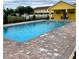 Community pool area with paving stones and small yellow building at 4871 Coral Castle Dr, Kissimmee, FL 34746