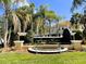 Elegant community entrance sign surrounded by manicured landscaping and palm trees at 4871 Coral Castle Dr, Kissimmee, FL 34746