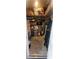 Deep storage room with shelves and abundant storage containers, including water heater at 4871 Coral Castle Dr, Kissimmee, FL 34746