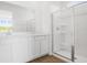 Bright bathroom features a double sink vanity with shaker cabinets and walk-in shower at 6385 Clover St, Lake Hamilton, FL 33851